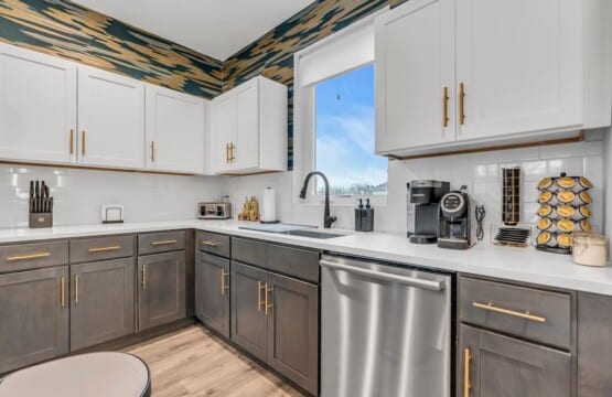 White kitchen with grey details and a mini coffee bar in the corner.