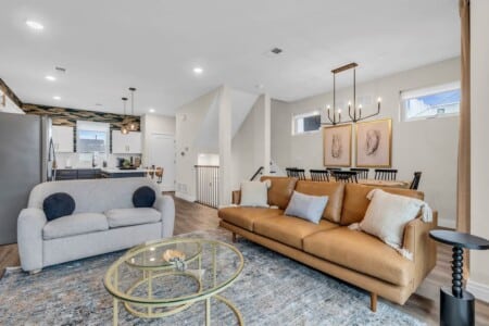 Open living room with connected kitchen and dining area in a bright, airy layout.