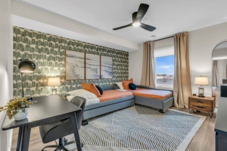 Room with two single beds facing a window with a scenic view.