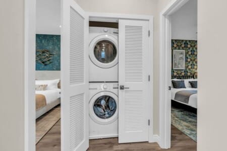 Closet space with washing machine and dryer side by side.