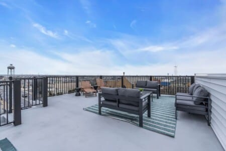 Outdoor balcony seating with Jersey neightborhood view.