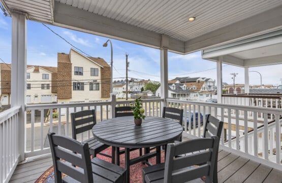 Looking a Jersey neighborhood with a table and vase holding a green plant.
