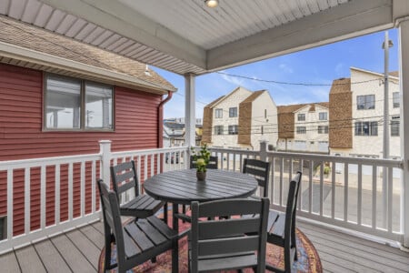 Balcony view of Jersey neighborhood featuring a table with a plant vase.