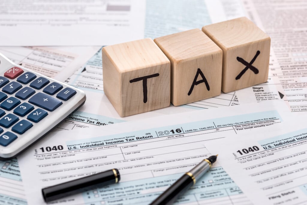 tax time wooden cubes, foem, calculator and pen