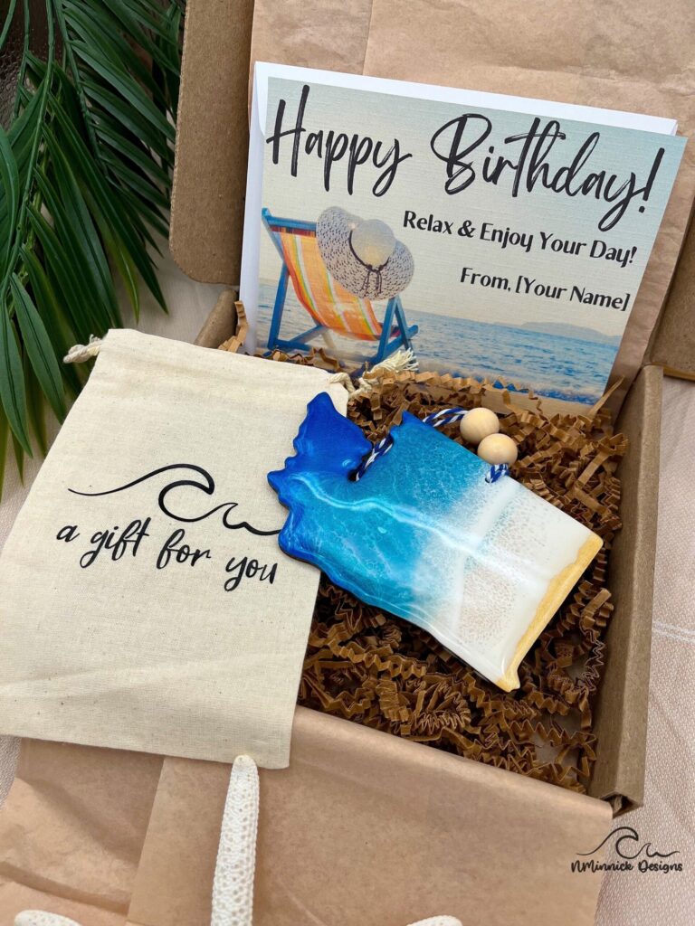 Birthday box with card featuring a sea drawing and a gift shell beside it.|Sunny Jersey street with people walking and various stores lining the road.|Close-up view of a store in a Jersey neighborhood.|Jersey town houses decorated with large logos of Puma